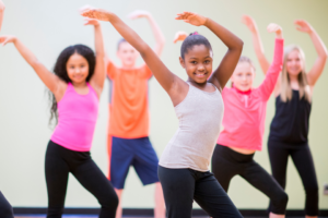 A group of children practicing a dance routine.