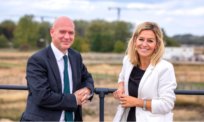 The CEO of Anglian Learning and Project Director of Urban and Civic stood infront of the building site in which the new school is to be built.